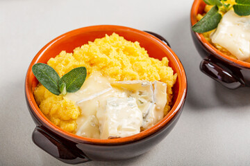Dish of polenta with melted gorgonzola cheese