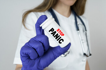 The doctor holds a medicine in his hands, which says - STOP PANIC