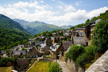 Fototapeta na wymiar Small village in the French Pyrenees with mountains in the background. High quality photo