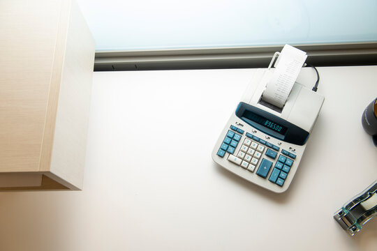Adding machine on a sparse minimal office desk