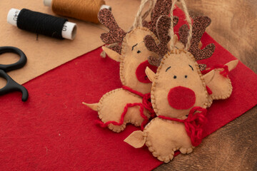 Christmas gifts and symbols over wooden background, handmade  toys from felt with own hands. Backgrond.