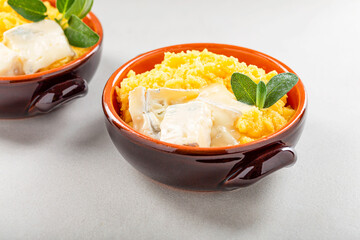 Dish of polenta with melted gorgonzola cheese