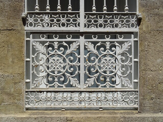 Detail of traditional window with beautiful smelting grill. Old city center of Alicante. Spain.