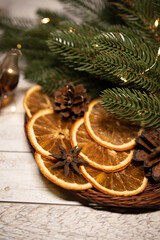 Christmas tea with dried orange in a basket with garland and fir branches and cones
