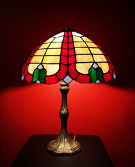 Colorful table lamp at night on the red background 