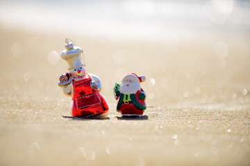 Christmas holiday concept. Toy snowman on the sea. Summer New Year.