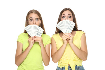 Young happy girlfriends holding dollar banknotes on white background