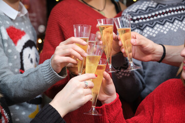 Unrecognizable group of friends at a Christmas party making a toast. Christmas celebration.