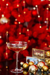 Christmas and New Year background. A glass of champagne against a background of bokeh lights.