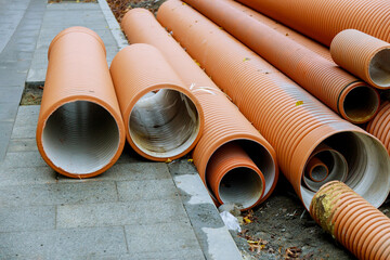 Plastic PVC pipes stacked in rows at a construction site on reconstruction of the city water system