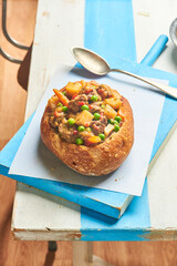 Goulash served in a bread bowl, a traditional beef stew of the Hungarian cuisine.
