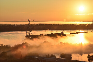 Obraz na płótnie Canvas dawn over the cable car across the river