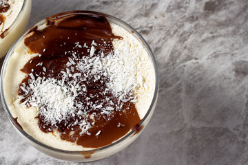 Dutch ketogenic pie covered in grated coconut and chocolate served in an individual bowl