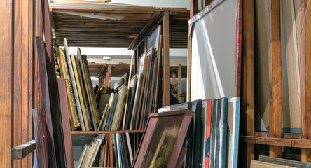 Wooden shelves full of pictures, Art gallery storage