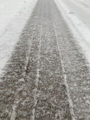 Tire tracks through fresh fallen snow. 