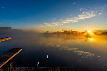 Sunrise on foggy lake in november