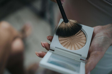 Closeup shot of a hand dipping a brush in a highlighter