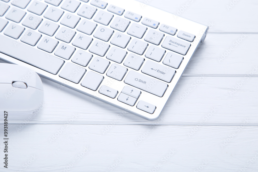 Poster computer keyboard and mouse on wooden table