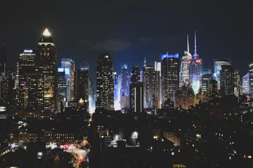 Tuinposter New York, NY, USA - June 29, 2019: Night Manhattan view from The Press Lounge © Andrey