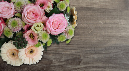 bouquet of roses in the upper left on wooden background  - copy space