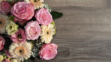 bouquet of roses on the left on wooden background  - copy space