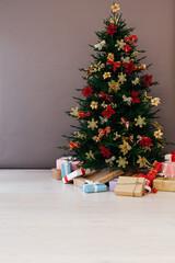 Christmas tree pine with new year gifts holiday red decoration decor gray background