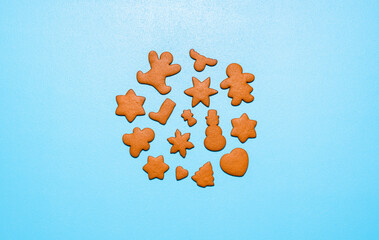 Gingerbread cookies in different shapes on a blue background. Homemade Christmas cookies