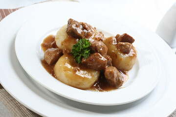 Silesian dumplings on white plate
