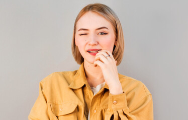 Portrait of attractive happy woman winking and flirting