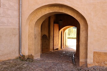 Naklejka premium Large arch in the thick wall for access to the courtyard