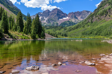 Maroon Bells and Maroon Lake - A wide-angle view of Maroon Bells at Maroon Lake on a sunny Summer day. Aspen, Colorado, USA.