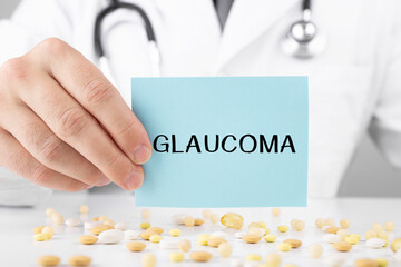 Doctor in a dressing gown holds a sticker with text Glaucoma