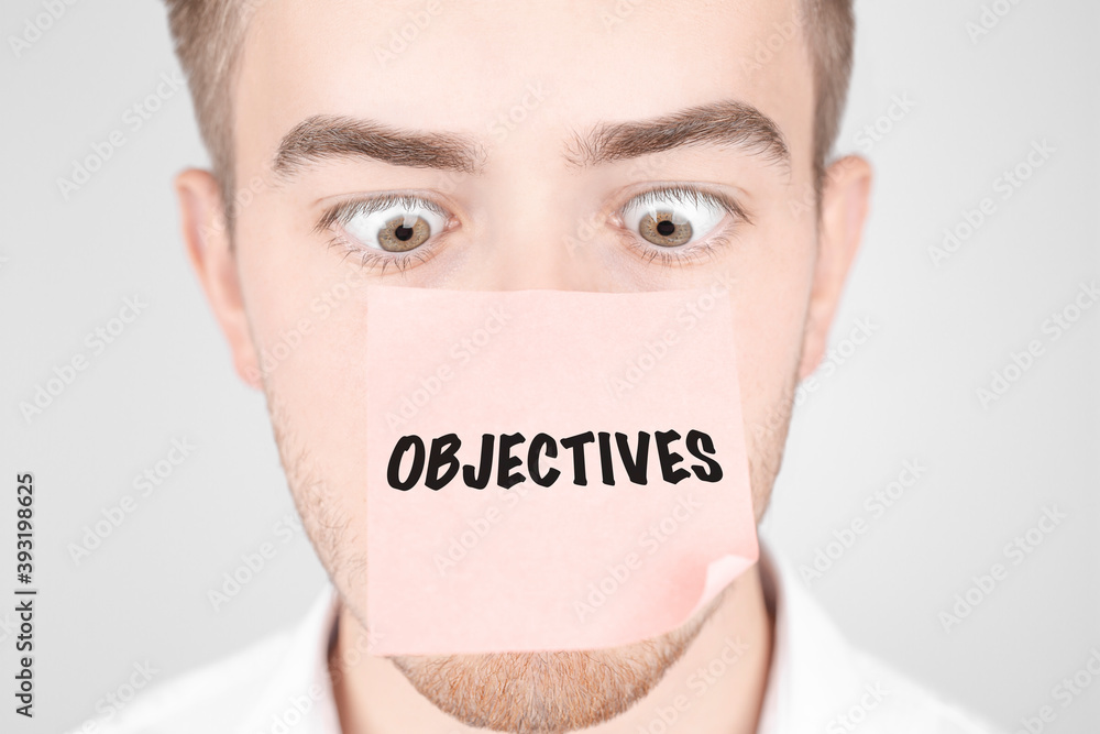 Poster man with a red sticker on his nose reads the text objectives