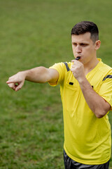 Referee showing on penalty while gaming. Concept of sport, rules violation, controversial issues,...