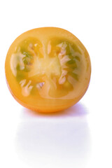 Halved yellow tomato on white background
