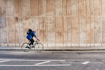 Full Length Of A Young Man Cycling In The City