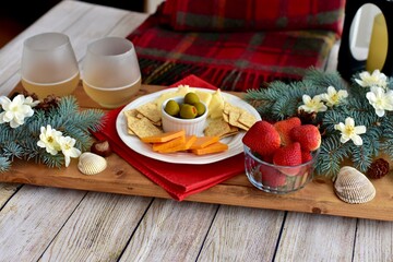 Festive winter Christmas holiday charcuterie board with white wine and seasonal decor ready for sharing