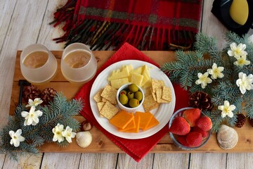 Festive winter Christmas holiday charcuterie board with white wine and seasonal decor ready for sharing
