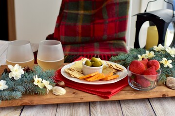 Festive winter Christmas holiday charcuterie board with white wine and seasonal decor ready for sharing