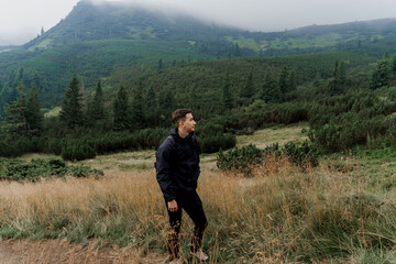 Hiking and climbing up to the top of the mountain. Men tourist is travelling and standing at the...