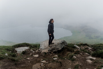 Obraz premium Men tourist is travelling and walking to the peak of mountain. Hiking and climbing up to the top of the mountain. Tourism in Ukraine.