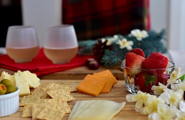 Festive winter Christmas holiday charcuterie board with white wine and seasonal decor ready for sharing