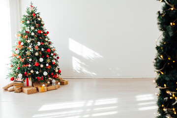 Christmas tree by the window interior of the room New Year holiday gifts