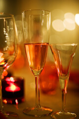 Holiday champagne, candle lights and festive feeling, blurry bokeh background.