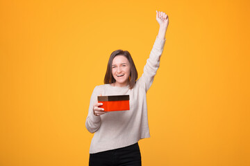 Just received the christmas gift, amazed young woman celebrating and holding gift box