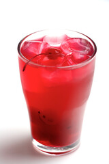 Drink with ice cubes and cherries on white background