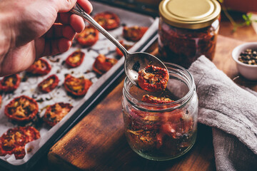 Preserving of Sun Dried Tomatoes with Thyme in a Jar - obrazy, fototapety, plakaty
