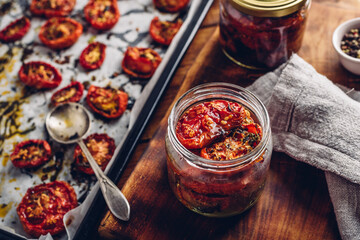Preserving of Sun Dried Tomatoes with Herbs in a Jar - obrazy, fototapety, plakaty