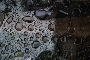 Rain drops on glass background. Raindrops on glass with reflection