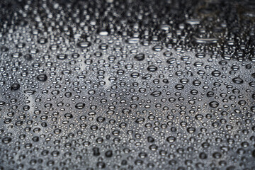 Rain drops on glass background. Raindrops on glass with reflection